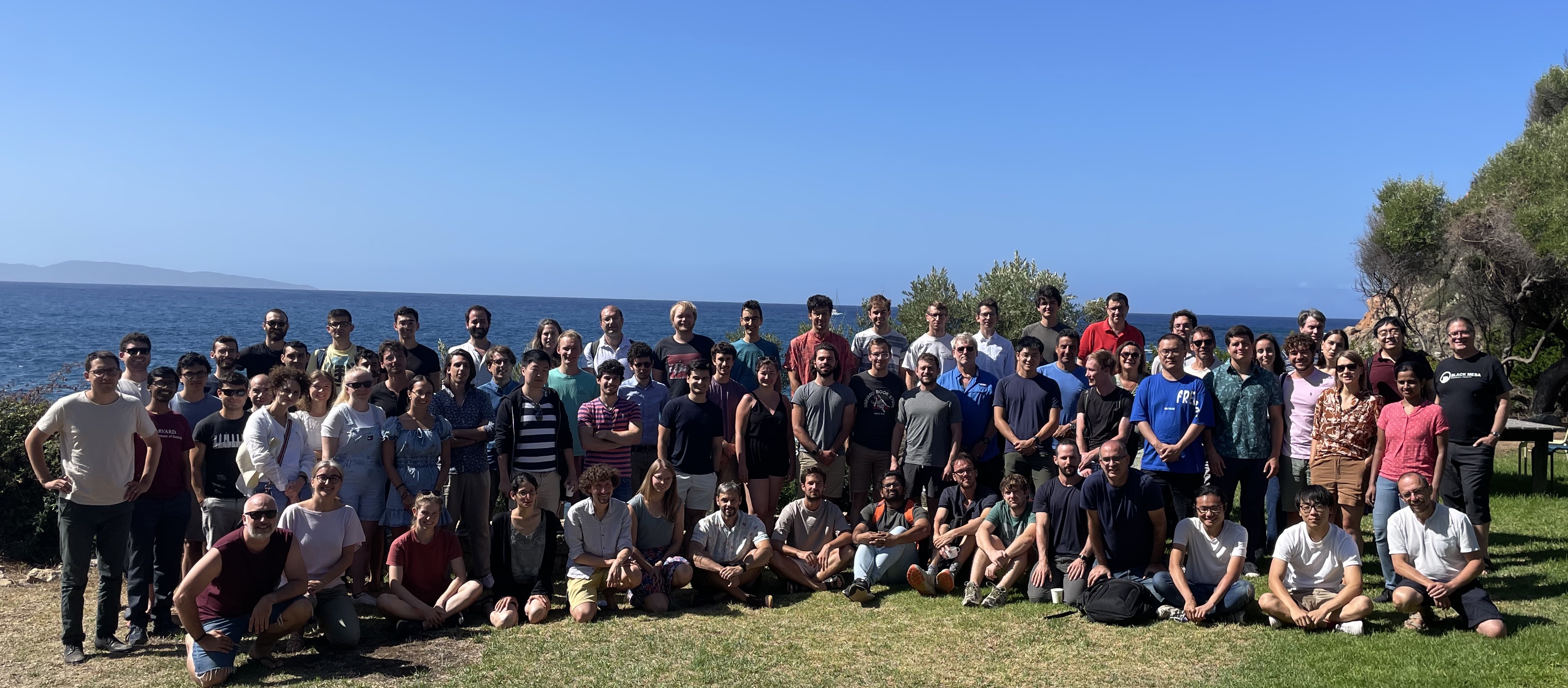 Participants gathered by the sea at the Cargèse institute